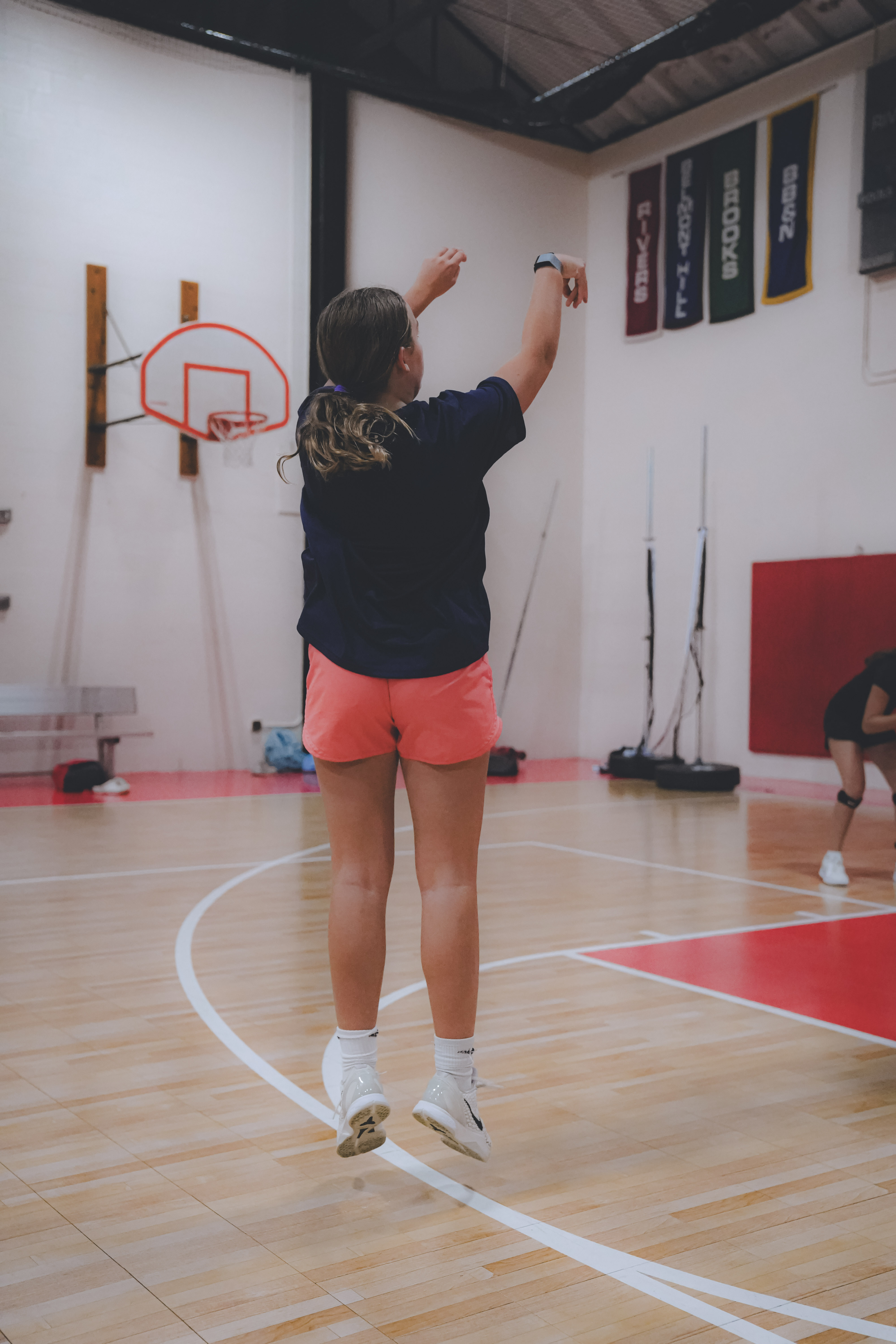 Coach working one-on-one with a young basketball player